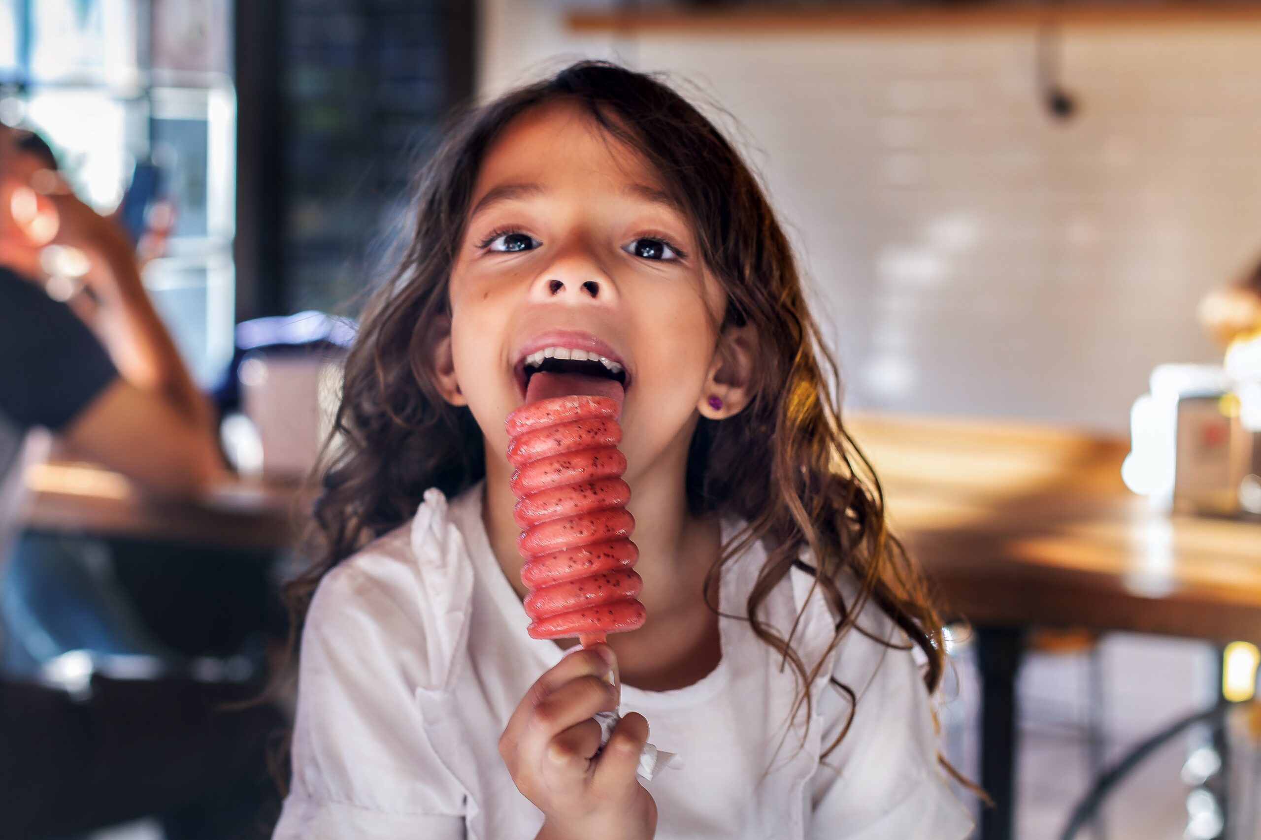 Girl licks ice lolly